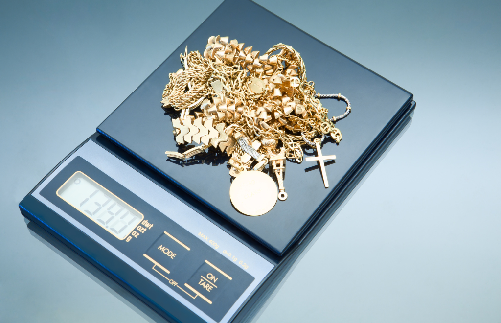 Jeweler weighing gold jewelry to check price
